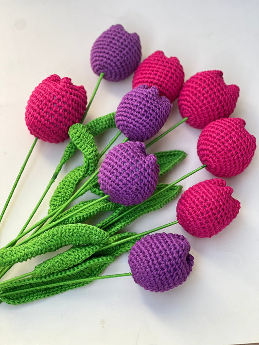 Crocheted tulips in purple and pink on a white background